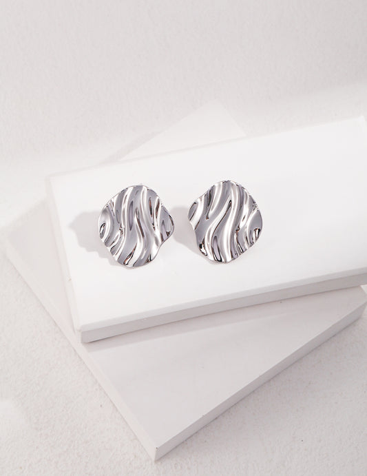 Stylish silver earrings with a wave pattern, perfect for a chic look.