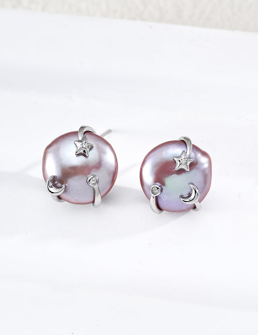 A sharp product shot displaying the silver Vesper Studs, highlighting the luminous coin pearl and the intricate star and moon setting.