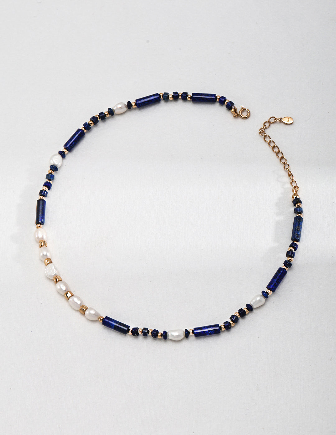 Elegant blue and white necklace featuring lapis lazuli and freshwater pearls.