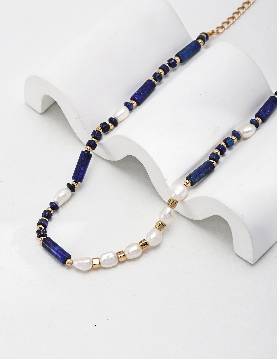 Stunning lapis lazuli necklace with intricate freshwater pearl details.