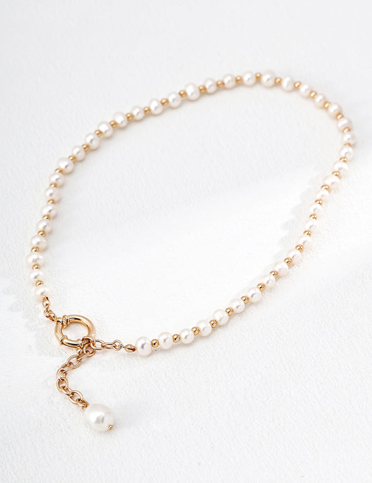 Mezuille Willow necklace in 18k gold vermeil featuring uniform freshwater pearls and a front-toggle closure on a white background.