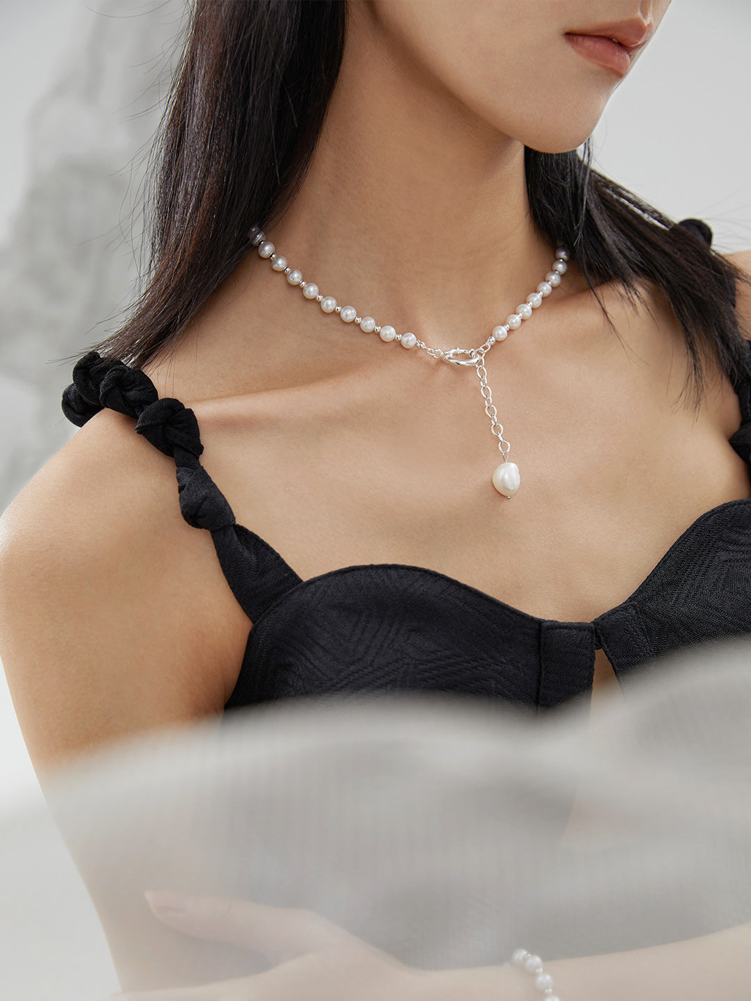 Side view of the Willow necklace in silver, showing how the lariat drop sits perfectly against the collarbone for professional wear.