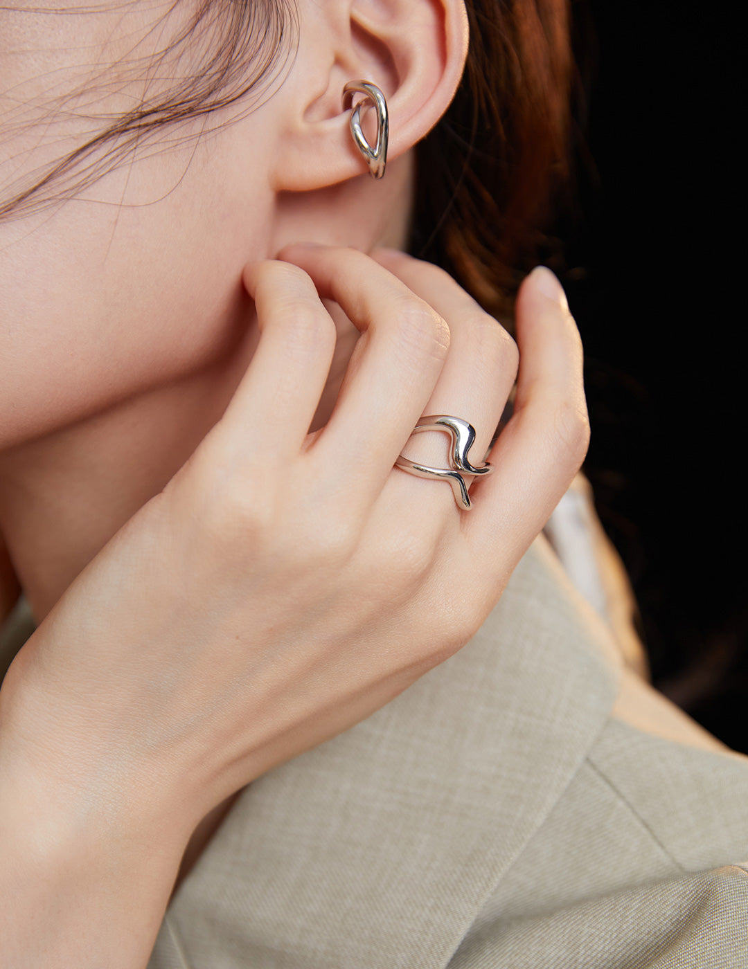 Model showcasing silver double band ring on finger.