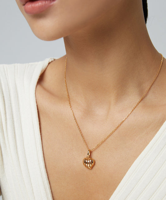 Woman in gold plated heart necklace.