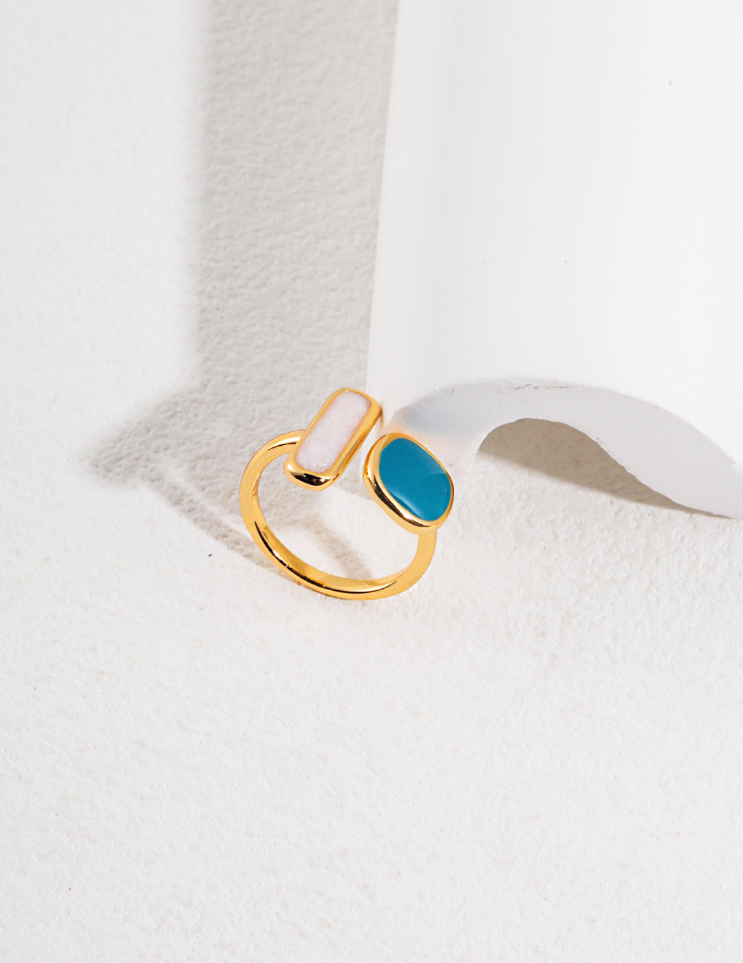 A stunning gold plated enamel ring with a blue and white stone, perfect for adding a touch of elegance to your look.