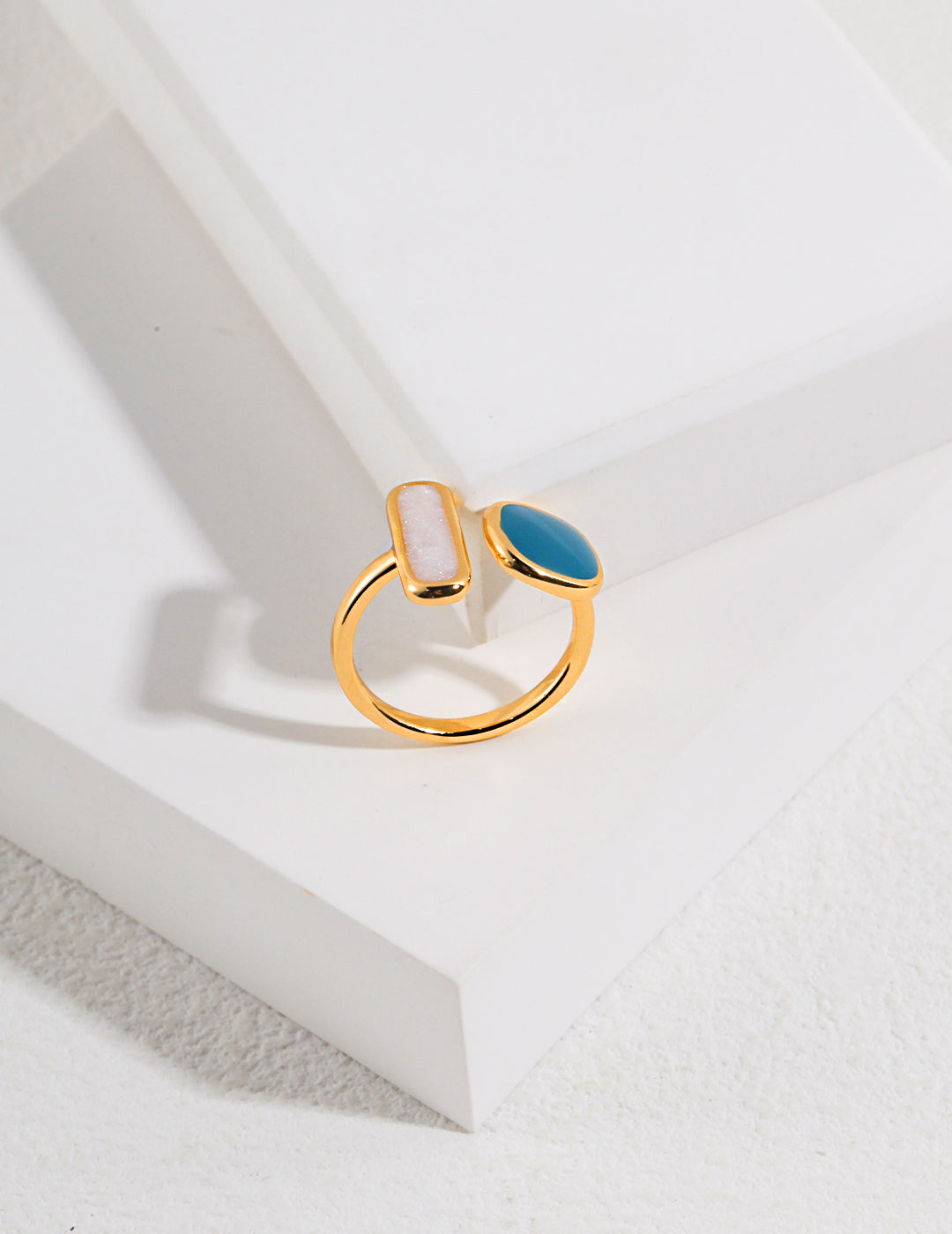 A stunning gold plated enamel ring adorned with turquoise and white stones.