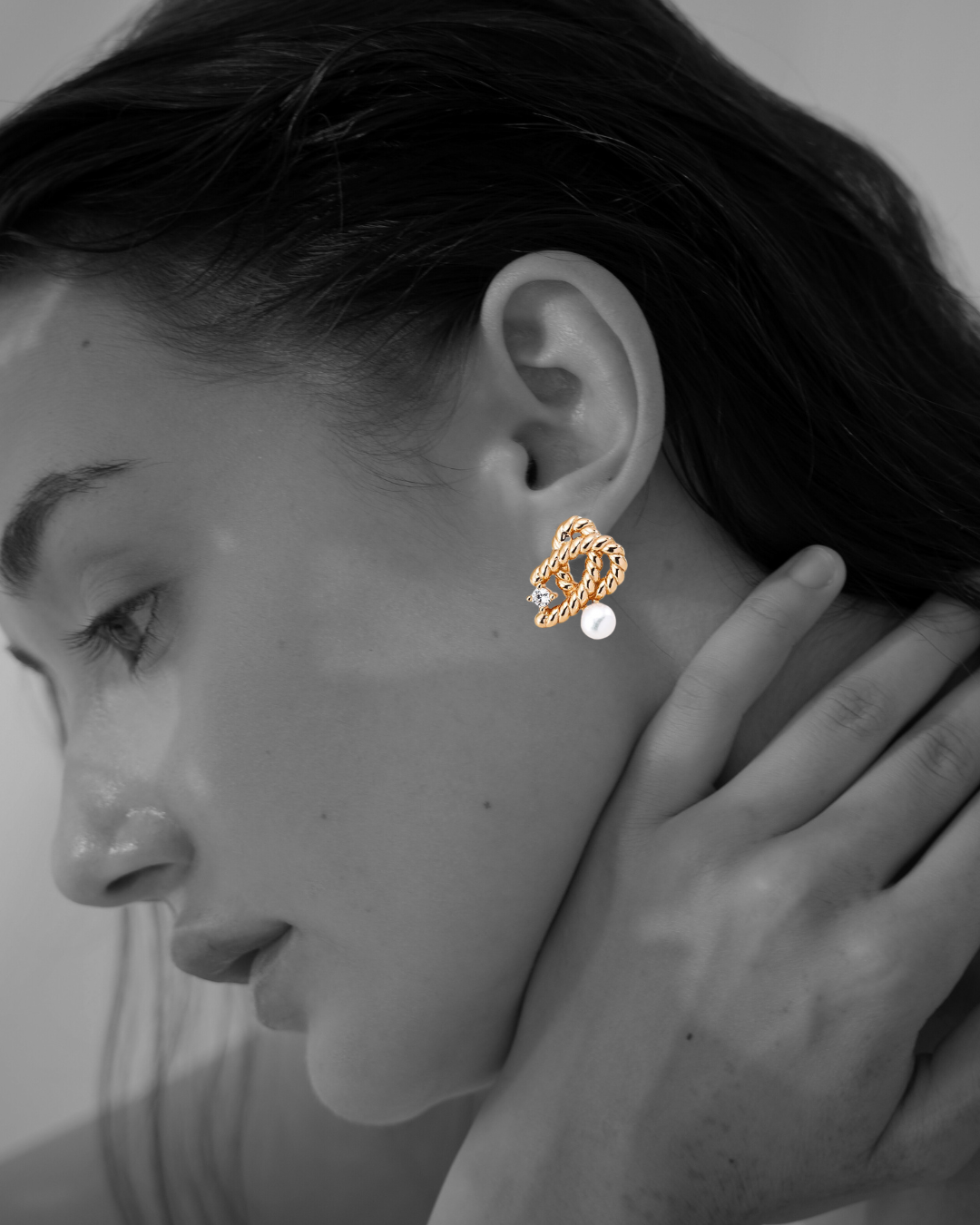 Woman wearing gold Amélie Studs by Mezuille captured in black-and-white photography.