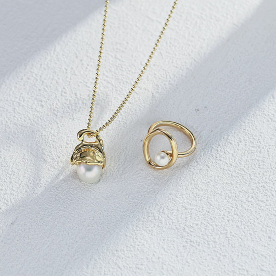 Video showing the luster and fluid movement of the Sloane ring and matching pearl pendant necklace.